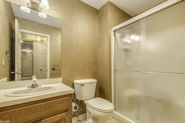 bathroom with tile patterned flooring, vanity, toilet, and a shower with door