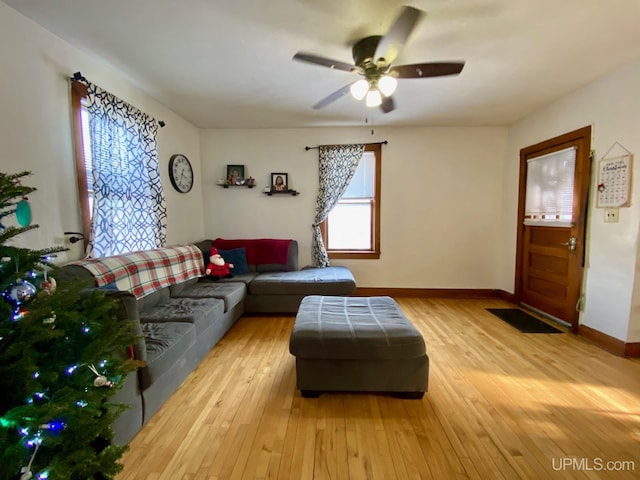 living room featuring ceiling fan and light hardwood / wood-style flooring