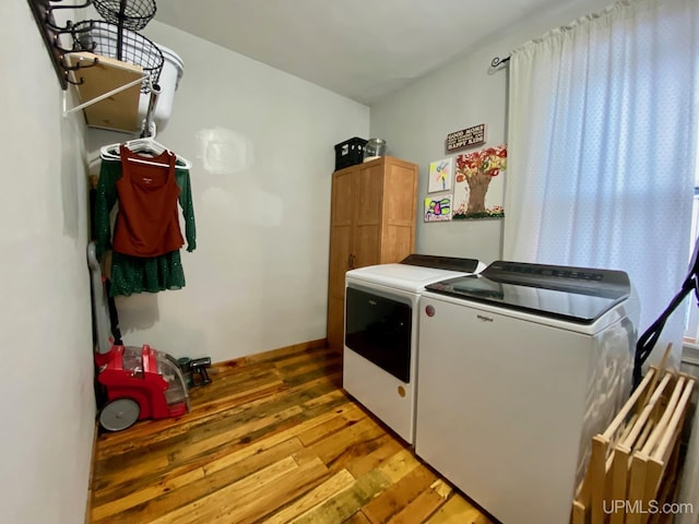 laundry room with washer and dryer and light wood-type flooring