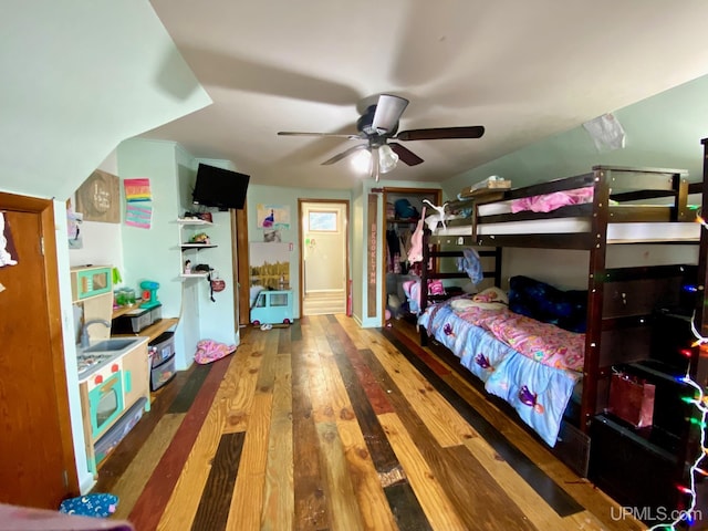 bedroom featuring ceiling fan, a closet, and wood-type flooring