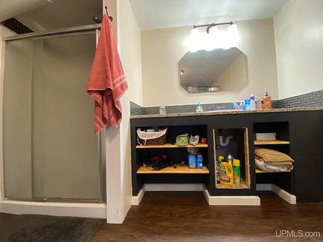 bathroom with an enclosed shower and wood-type flooring