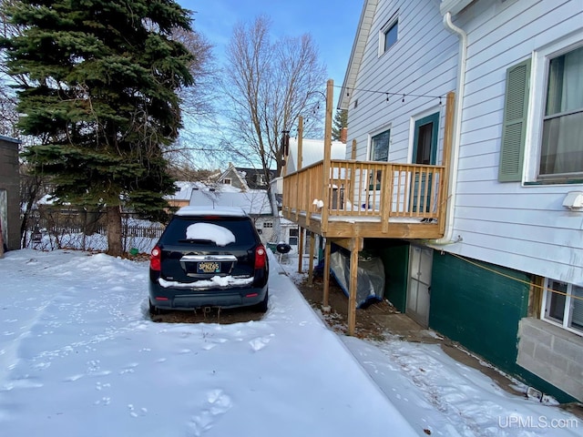 view of snow covered exterior featuring a deck