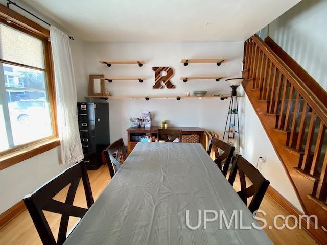 dining room with plenty of natural light and light hardwood / wood-style flooring