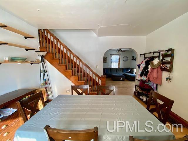 dining room with ceiling fan and hardwood / wood-style flooring