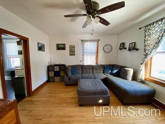 living room featuring ceiling fan and light hardwood / wood-style floors