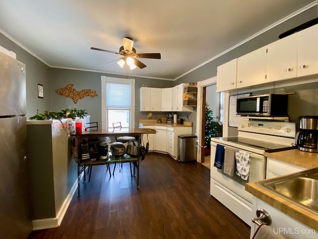 kitchen with white cabinetry, stainless steel appliances, dark hardwood / wood-style floors, ornamental molding, and ceiling fan