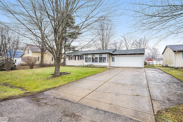 ranch-style house featuring a front yard and a garage