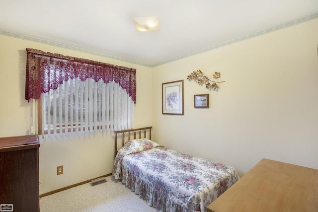 carpeted bedroom featuring ornamental molding