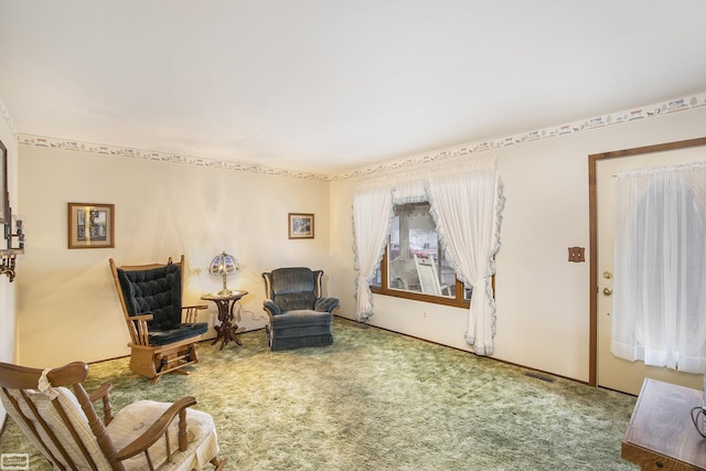 sitting room featuring carpet flooring