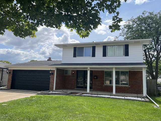 view of property with a porch, a garage, and a front yard