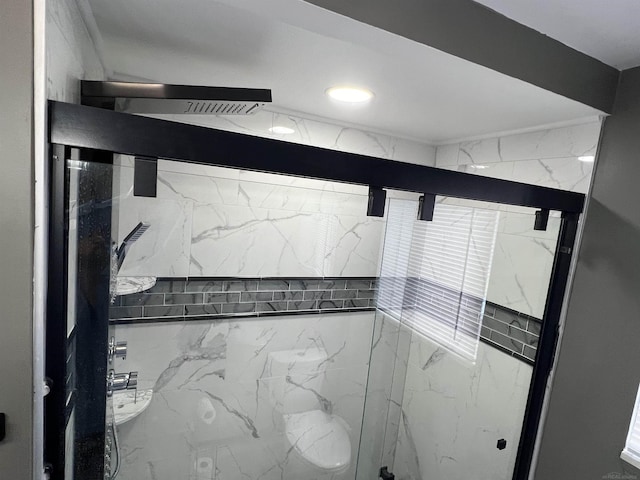 bathroom with a shower with door