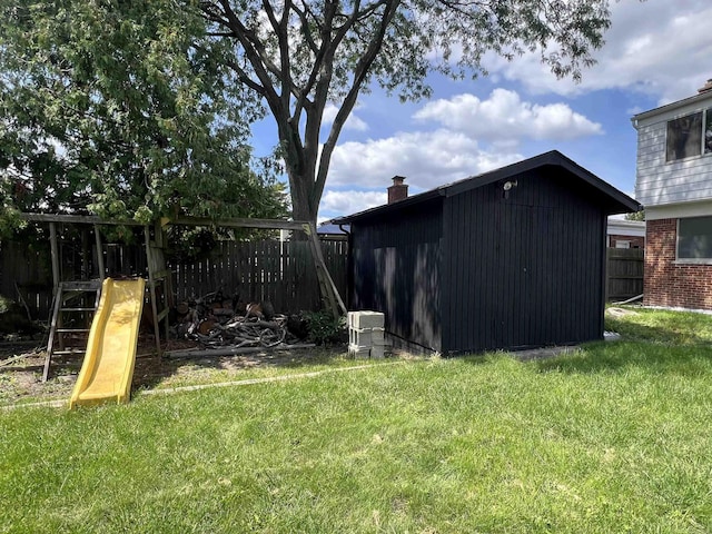 view of yard with a playground and a storage unit