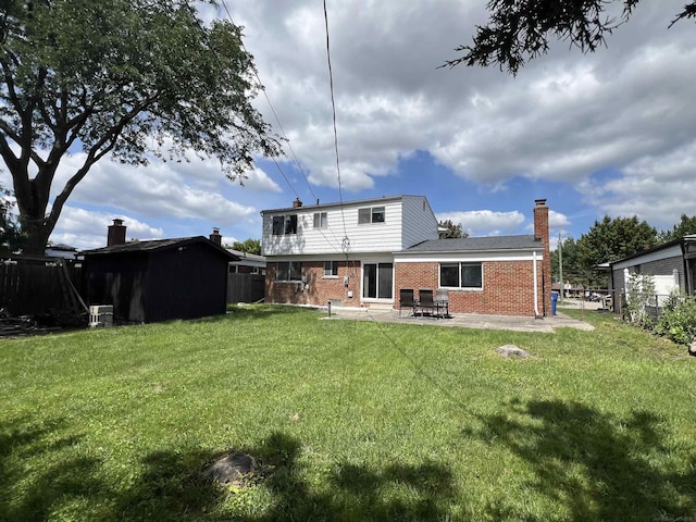 rear view of house with a yard and a patio area