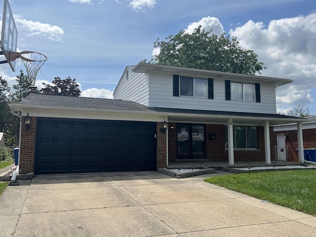 front facade featuring a front yard, french doors, and a garage