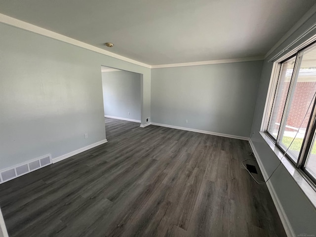 unfurnished room featuring crown molding and dark hardwood / wood-style flooring