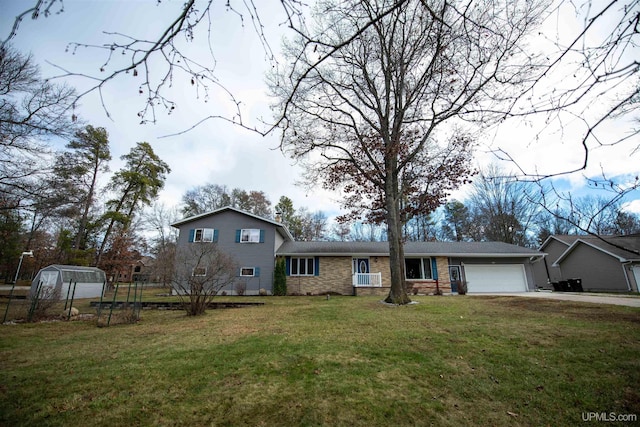 split level home with a front lawn and a garage