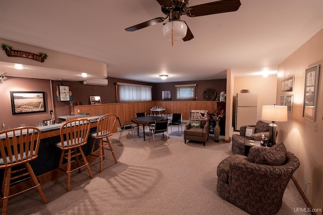 dining room with ceiling fan, an AC wall unit, and carpet floors