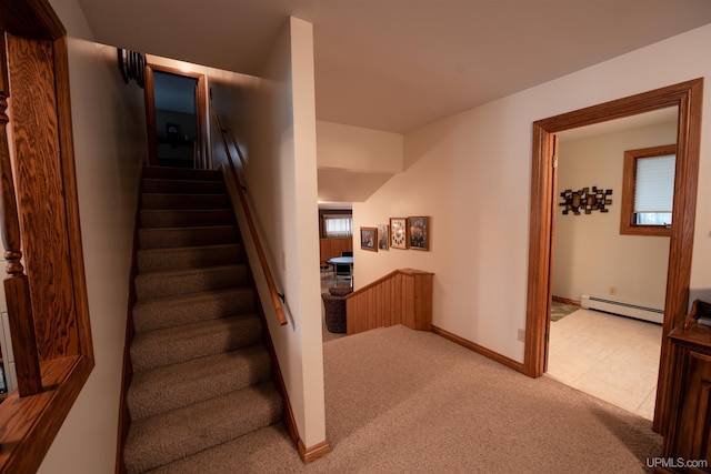 stairway with carpet and a baseboard radiator