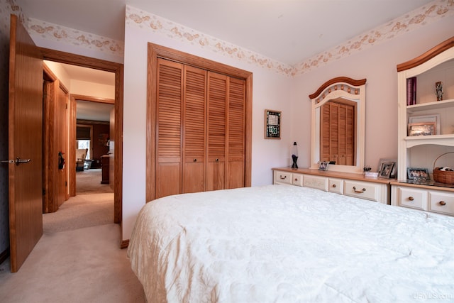 bedroom featuring light colored carpet and a closet