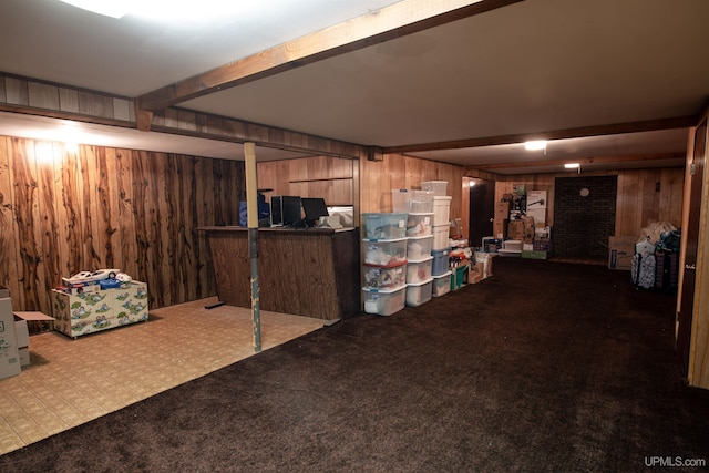 basement featuring carpet flooring and wooden walls