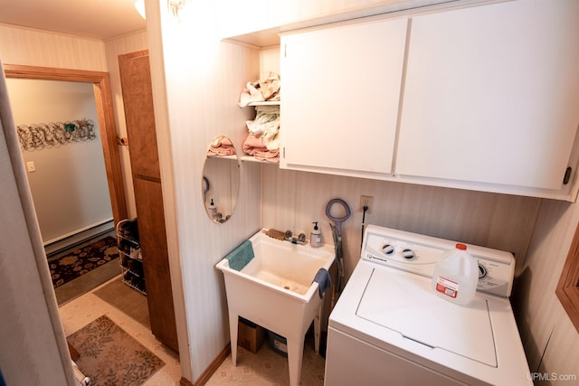 clothes washing area featuring cabinets, washer / clothes dryer, and baseboard heating