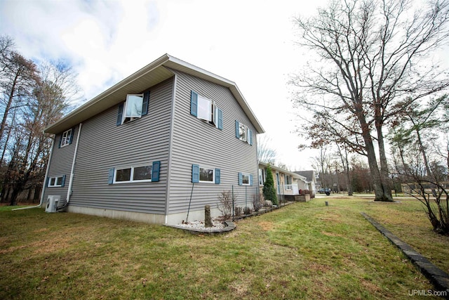 view of side of home with a lawn