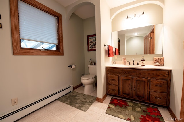 bathroom featuring baseboard heating, tile patterned flooring, vanity, and toilet