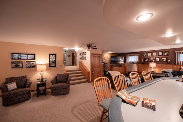 carpeted dining space with ceiling fan