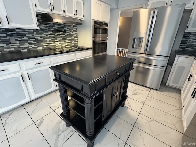 kitchen featuring backsplash, white cabinets, and appliances with stainless steel finishes