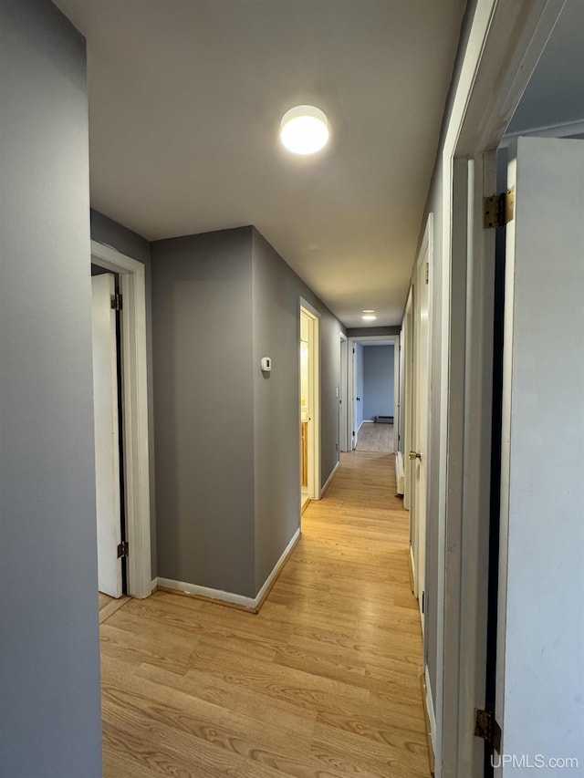 corridor featuring light hardwood / wood-style floors