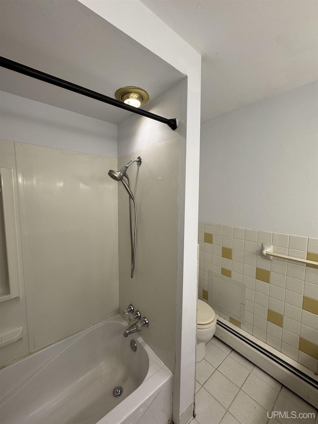 bathroom with tub / shower combination, a baseboard heating unit, tile walls, tile patterned flooring, and toilet