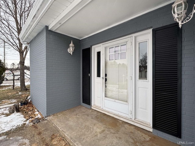 view of snow covered property entrance