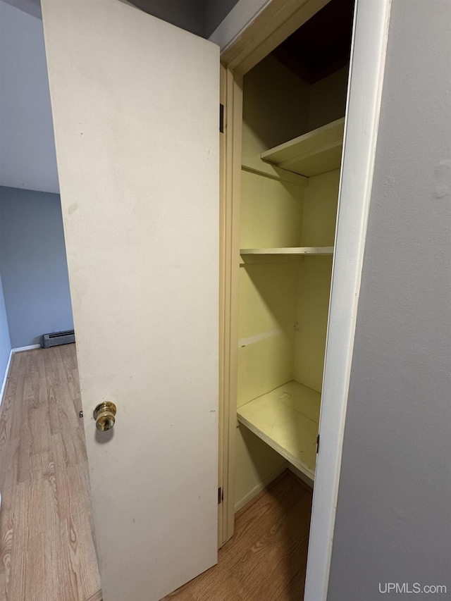 closet with a baseboard radiator