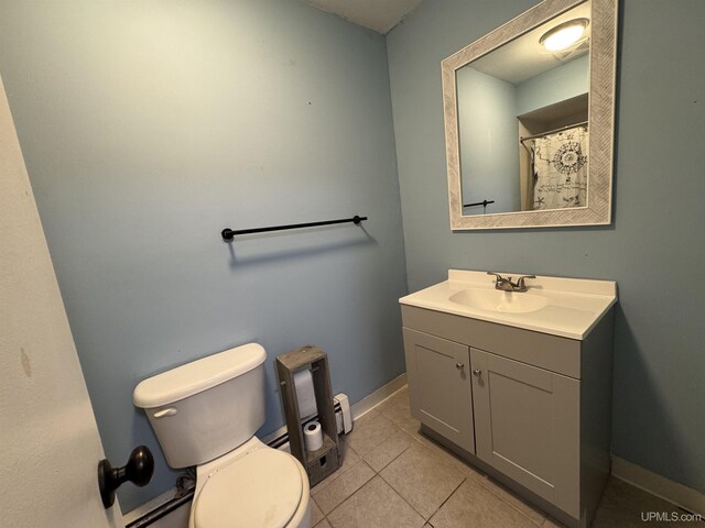 bathroom featuring tile patterned floors, vanity, and toilet