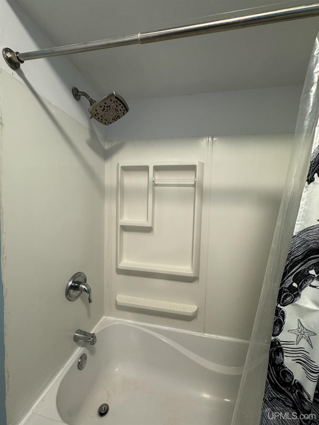 bathroom featuring shower / tub combo with curtain