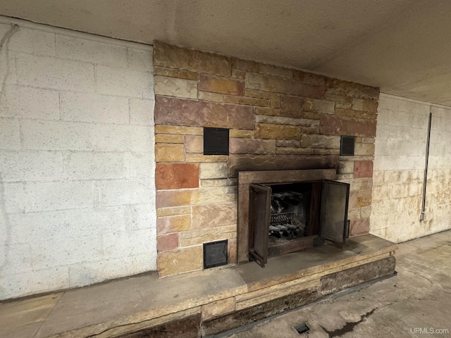 interior details featuring a stone fireplace