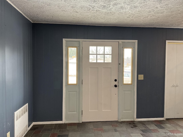 entryway featuring wood walls and radiator