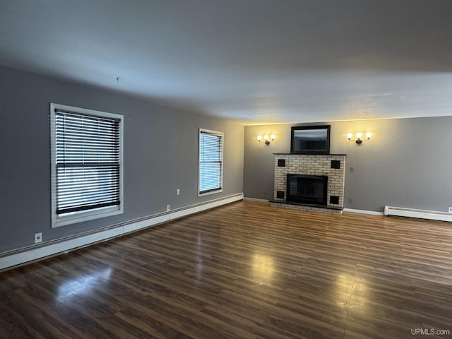 unfurnished living room with a fireplace, dark hardwood / wood-style floors, and baseboard heating