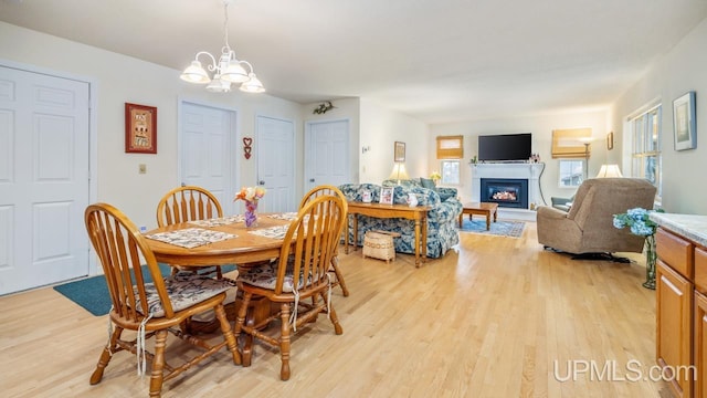 dining room featuring light hardwood / wood-style flooring and a notable chandelier