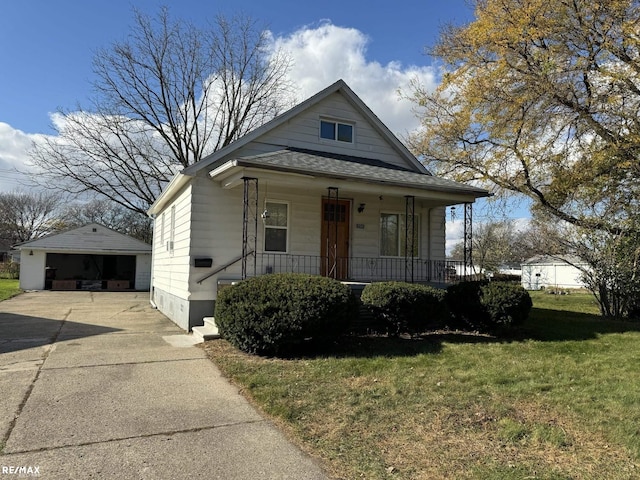 bungalow-style house featuring a front yard, covered porch, an outdoor structure, and a garage