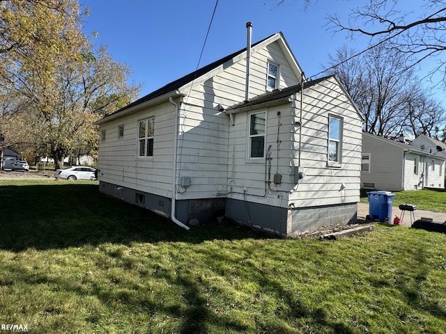 view of property exterior with a lawn