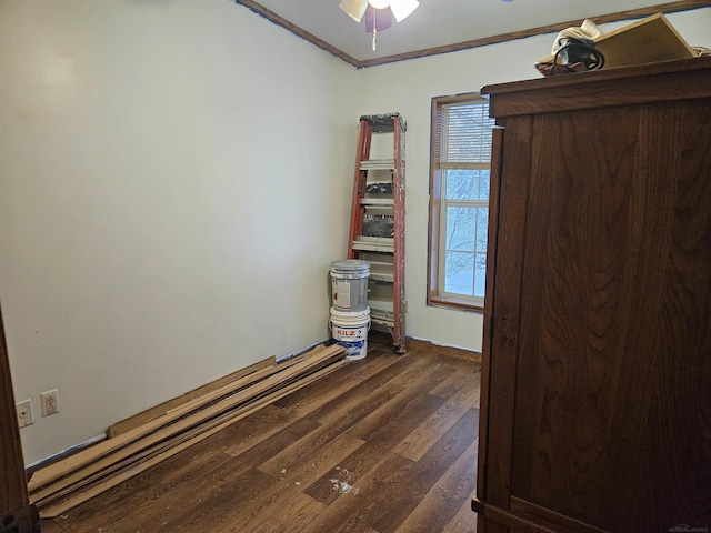 unfurnished room with dark hardwood / wood-style flooring, ceiling fan, and crown molding