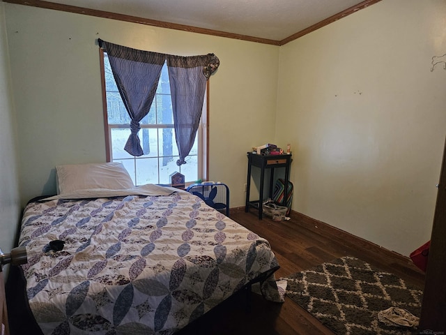 bedroom featuring crown molding and dark wood-type flooring