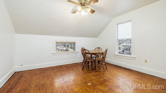 dining room featuring wood-type flooring, vaulted ceiling, and ceiling fan