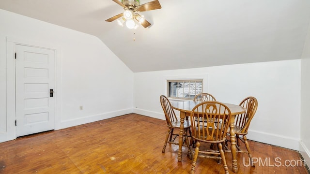 dining space featuring hardwood / wood-style flooring, ceiling fan, and lofted ceiling