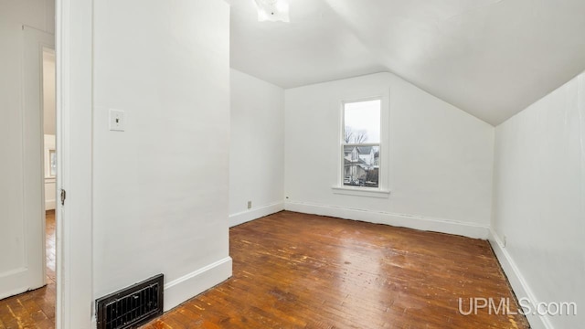 bonus room featuring dark hardwood / wood-style flooring and vaulted ceiling