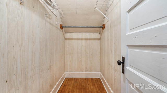 walk in closet with wood-type flooring