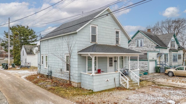 bungalow-style home with a porch and a garage