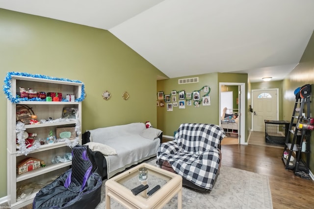 living room featuring hardwood / wood-style floors and vaulted ceiling