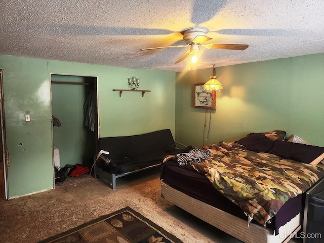 bedroom featuring ceiling fan, carpet floors, and a textured ceiling